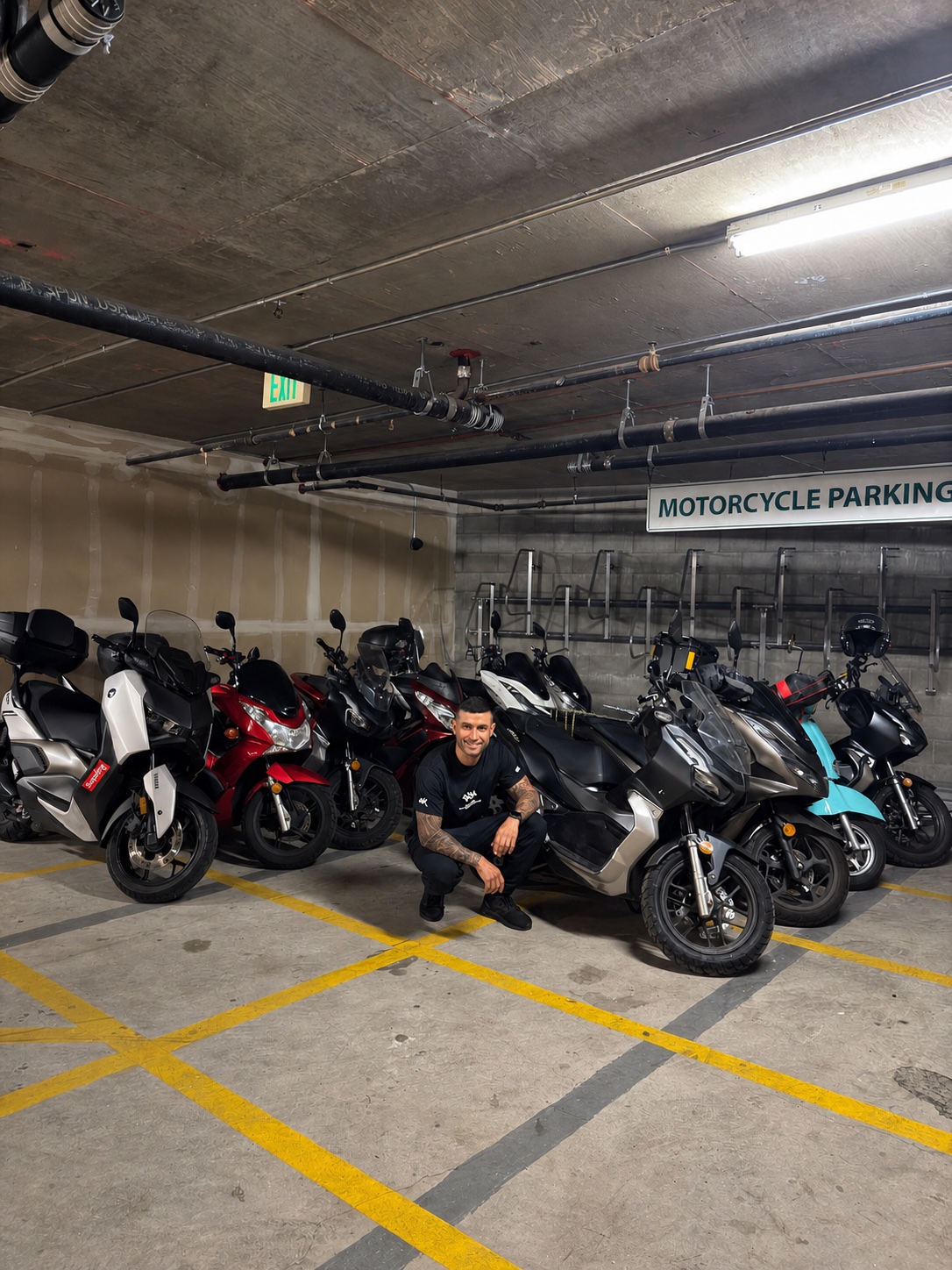 A Real Facts team member with scooters in a motorcycle parking garage