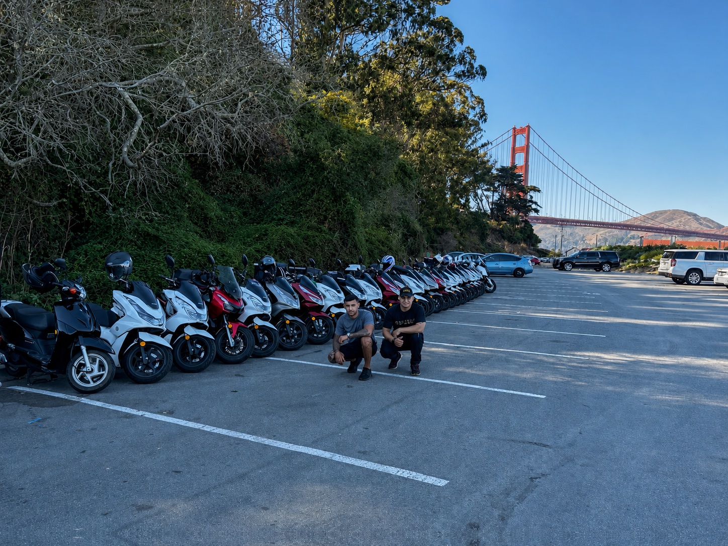 Real Facts scooter fleet with two team members and the Golden Gate Bridge in San Francisco